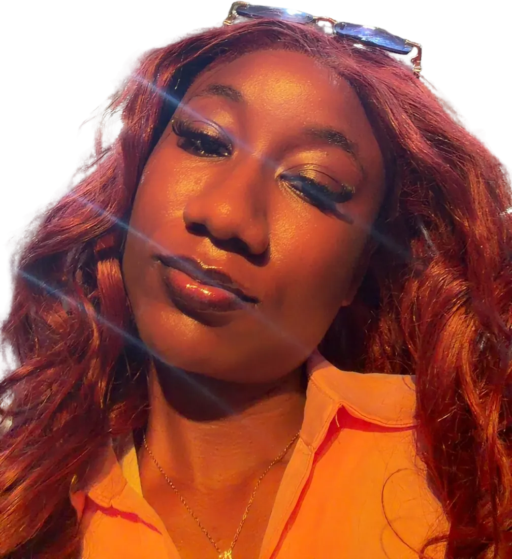 Close-up selfie of Blaire with sunglasses pushed up into her hair and soft glam makeup